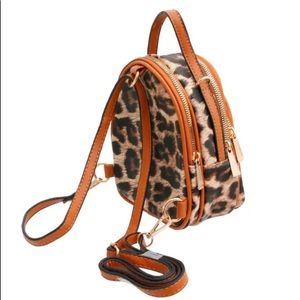 A mini brown leopard leather backpack .